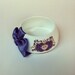 StayGoldMaryRose - Lovely lavender and gold regal pattern tea cup bracelet with lavender hand made satin bow.