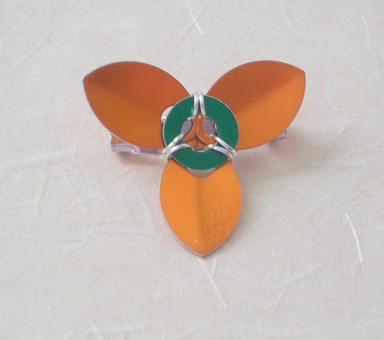 Trillium Brooch.  Orange, Green, and Silver.