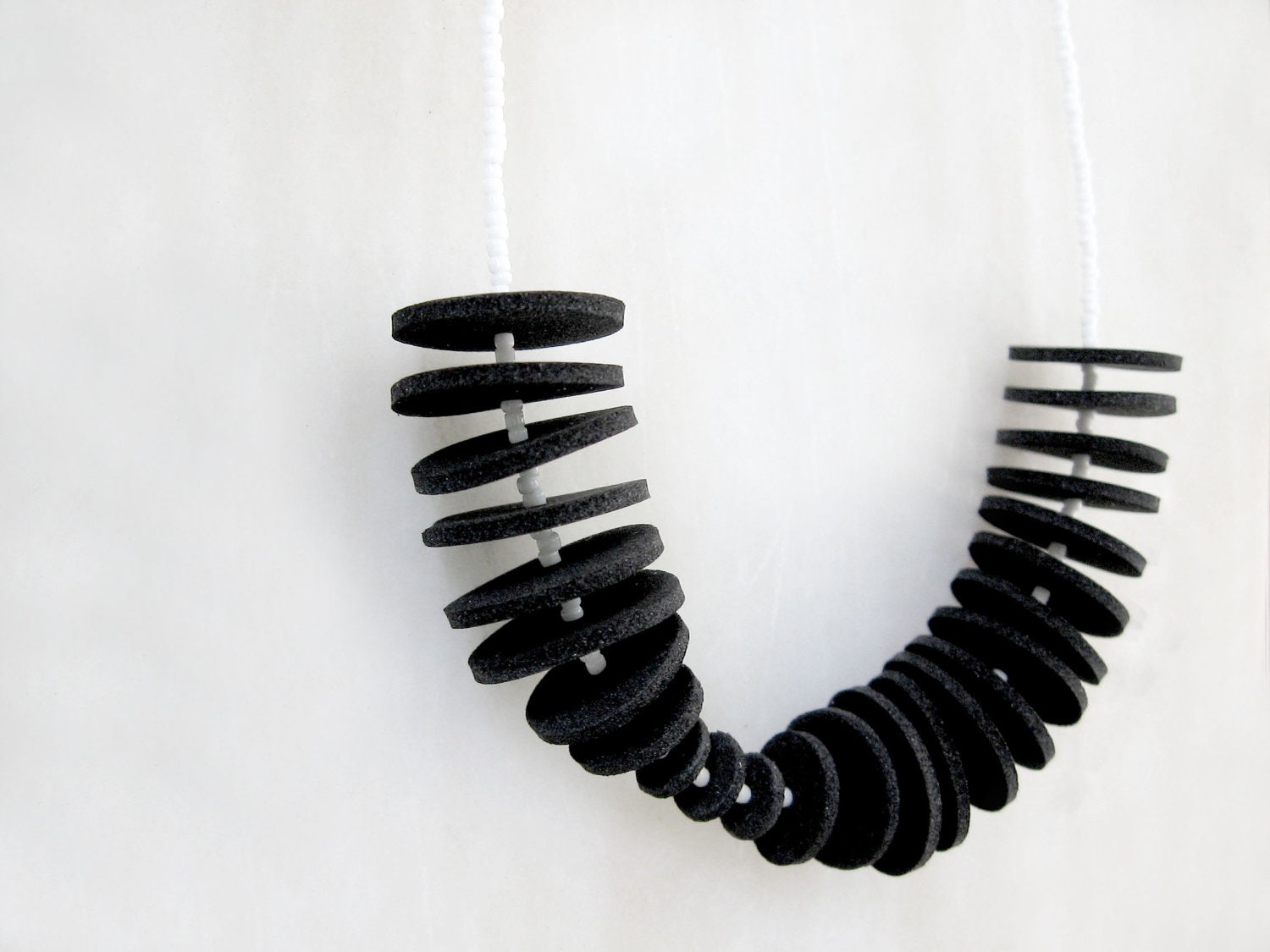 minimal geometric necklace with black circles and black & white beads - contemporary jewelry