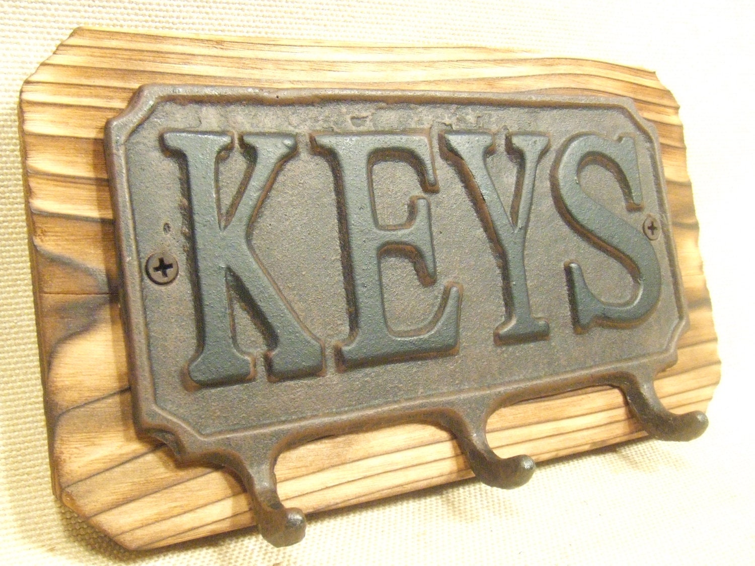 Rustic Cast Iron Key rack  -- lodge cabin decor -- rich patina on cast iron hooks and western cedar
