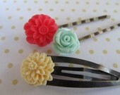 A set of three shabby chic hair pins in poppy red, mint green and cream