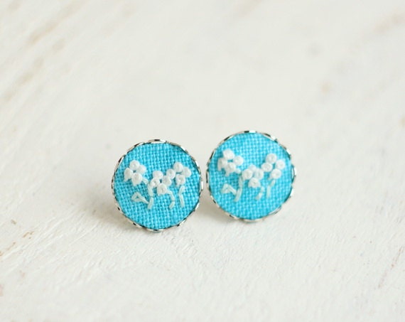 Mint blue stud earrings with floral ornament