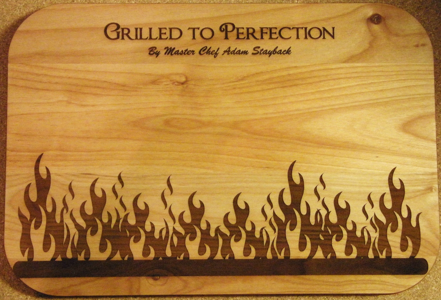 Laser engraved barbeque wood cutting/serving board for the master griller in your life.