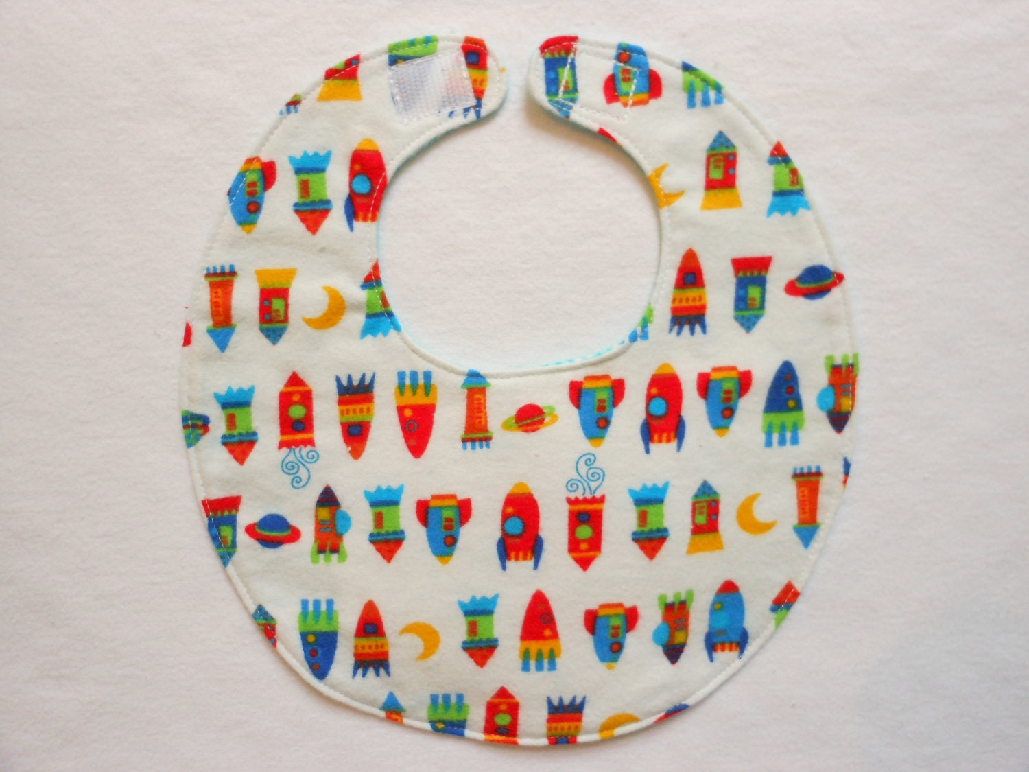 Baby bib, four soft layers, reversible, white with colorful space ships