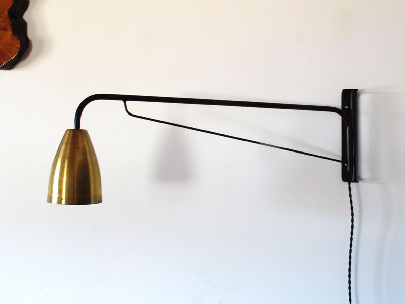 Black powder coated swiveling wall lamp with brass shade