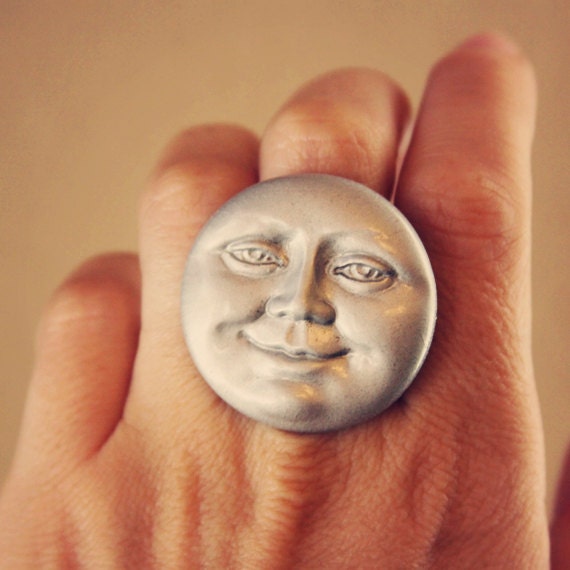 luna.  a large silver moon face cab ring.