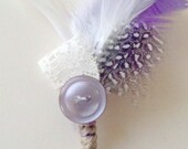 Purple vintage inspired boutonniere with feathers, lace, and button