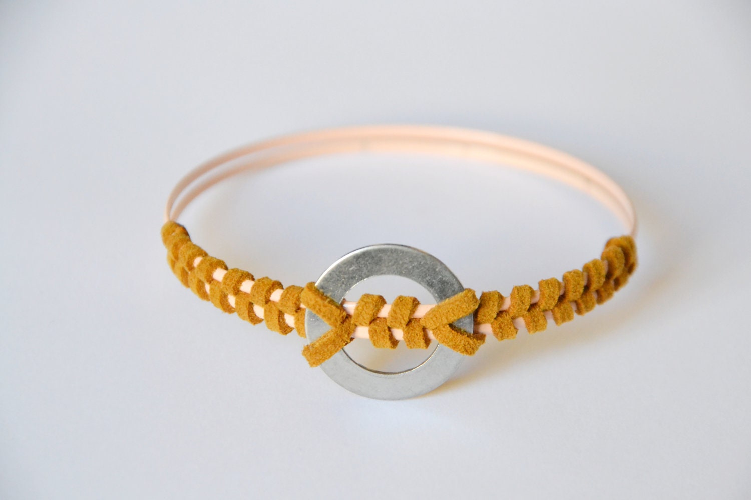 Saddle Brown bangle. Suede hand wrapped around two peach bangles with vintage nuts & bolts tribal piece. Large size.