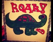 dino-roar acrylic paining dinosaur on 12X12 staple back canvas with ribbon boarder and button eyes