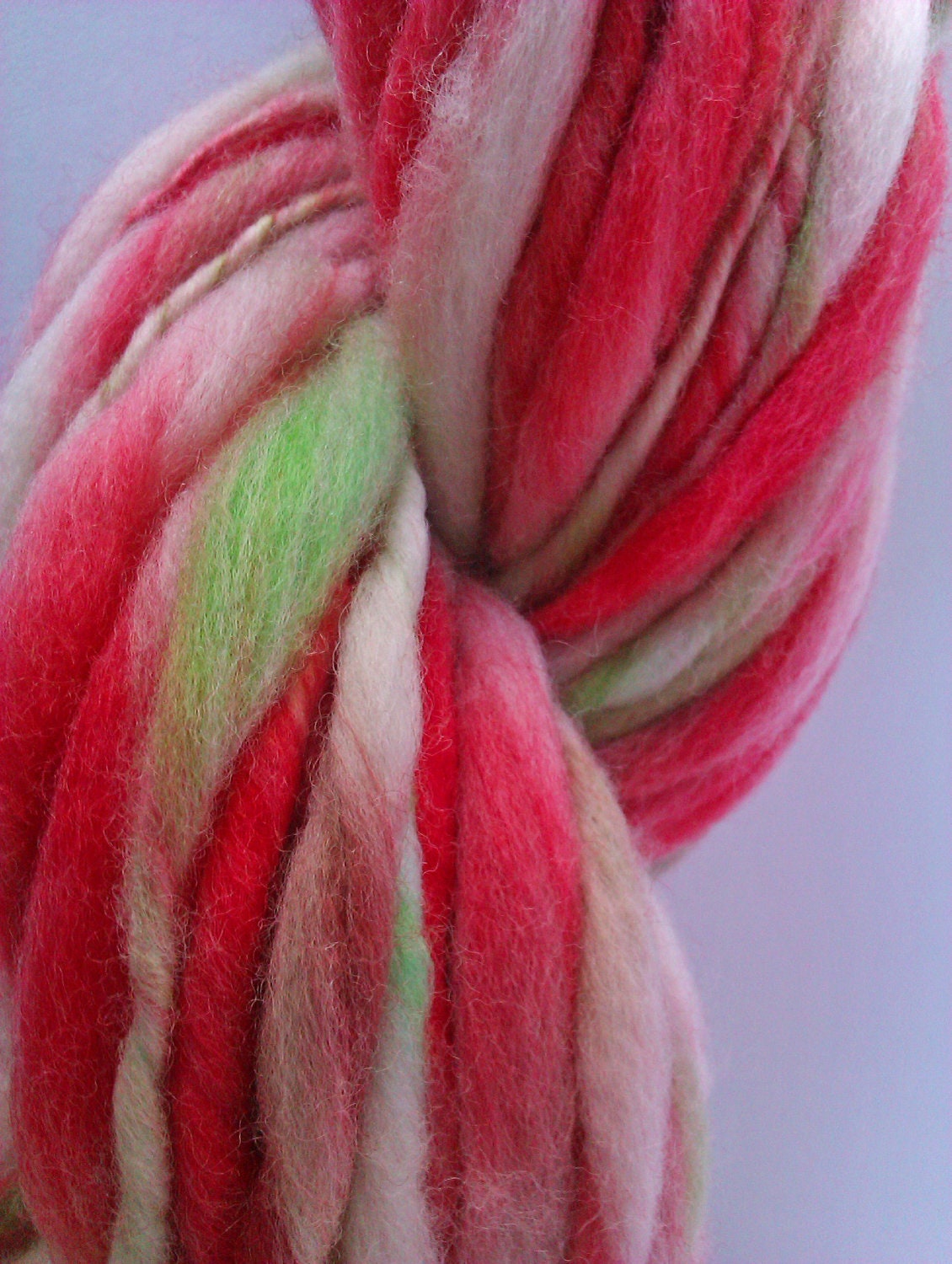 She's apples - thick and thin. - Hand spun, hand dyed slub yarn. Pure Australian 21 micron merino wool.
