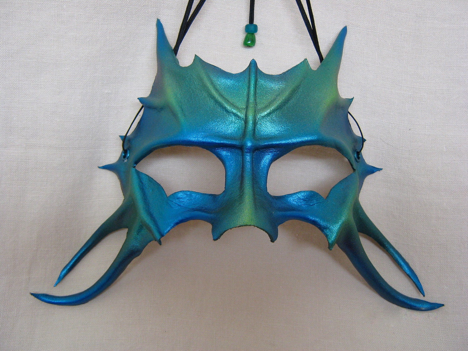 Blue-green leather mask, water dragon youngling, or catlike aquatic being...