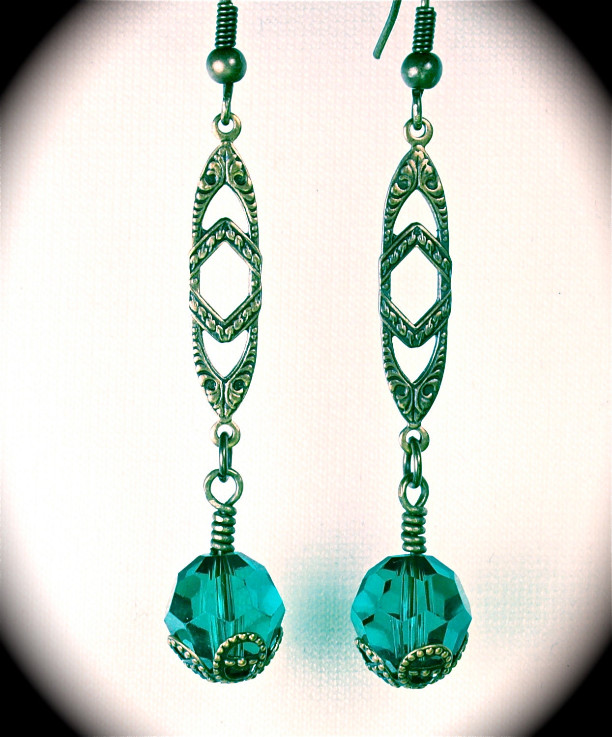 Long brass filigree earring with Swarovski fern green crystal capped with vintage brass filigree.
