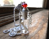 The Haunted House Necklace by Amanda Olivo - A young womens finger bone in a tiny glass jar - vial pendant removable cork top lid cap opens