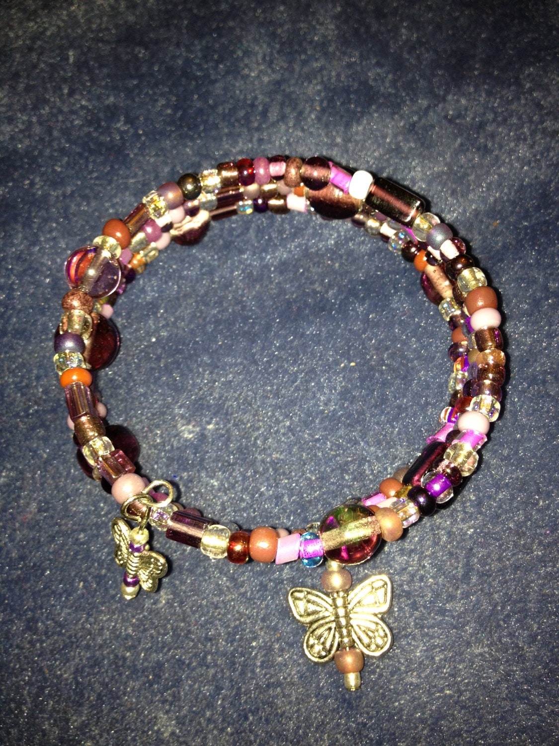 Purple Beaded Silver plated Wire Wrapped 3 Tier Bracelet with two butterfly charms.  Easy on and off, fun, colorful, unique