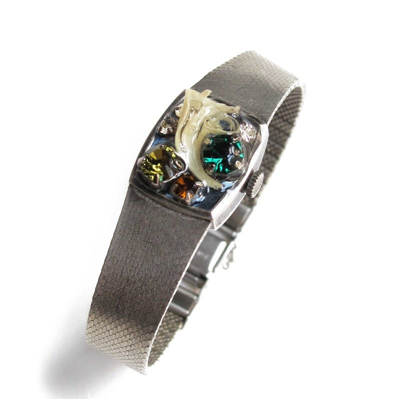 Watch-like handmade jewelry bracelet encrusted with assorted tiny stones gems and silver strap