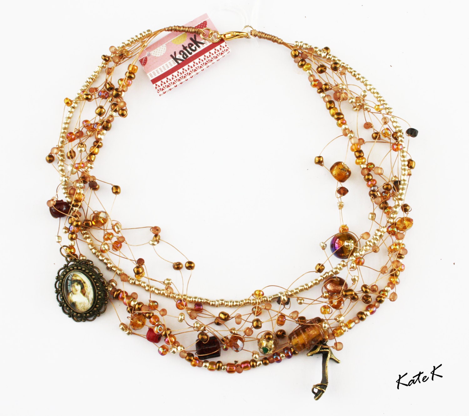 A handmade champagne, gold and pearl beadwork necklace with a Victorian theme.