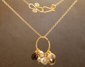 Necklace 115 Hammered circle with a cluster of nine assorted neutral color stones