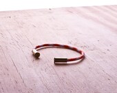 Dreamsicle Camo Bullet Casing Bracelet recycled .22lr casings orange white paracord wire BRZN