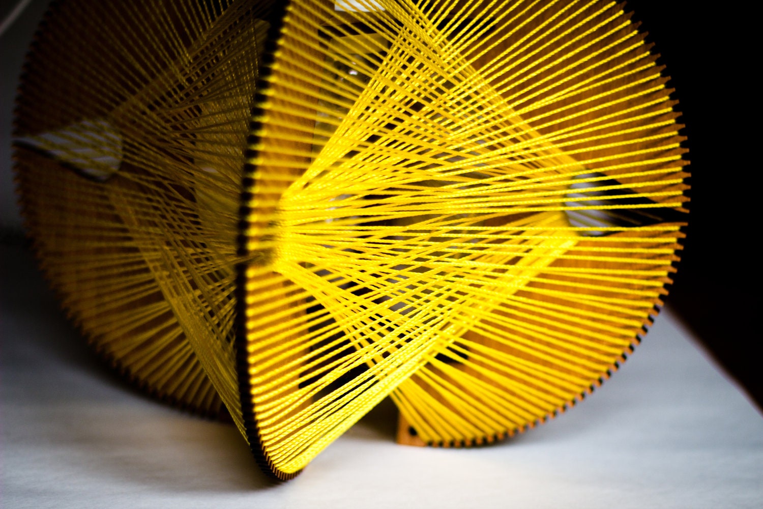 Stylish hanging lamp - light walnut and yellow web accents an industrial influence