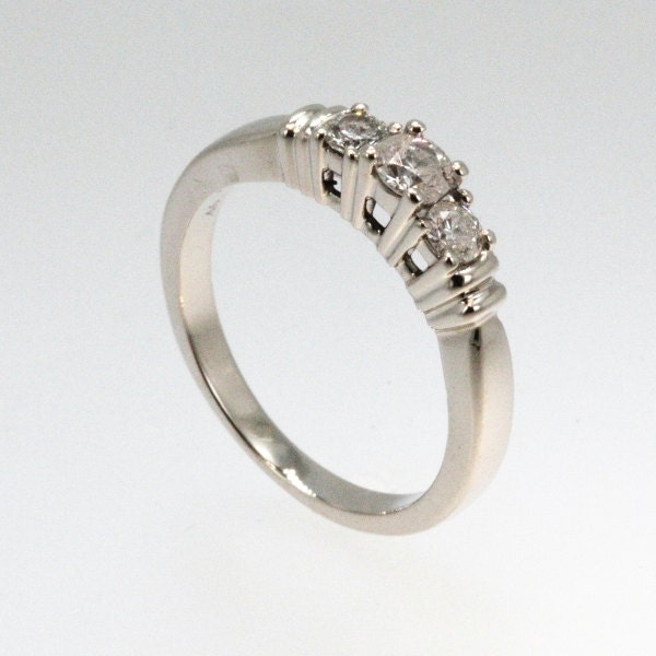 Wedding Ring made in 14K White Gold with a 3 stone setting