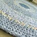 Crochet rag rug in shades of periwinkle blue. Denim, chambray. Eco friendly. 35" round.