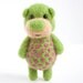 Light green pocket bear with violet polka dots