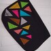Triangle zipper clutch in black.