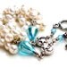 The snow white bracelet. white pearl wrapped bracelet. blue crystal. stars and moon beads