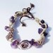 Amethyst matched with metal beads featuring LOVE and PEACE to all in this bracelet.