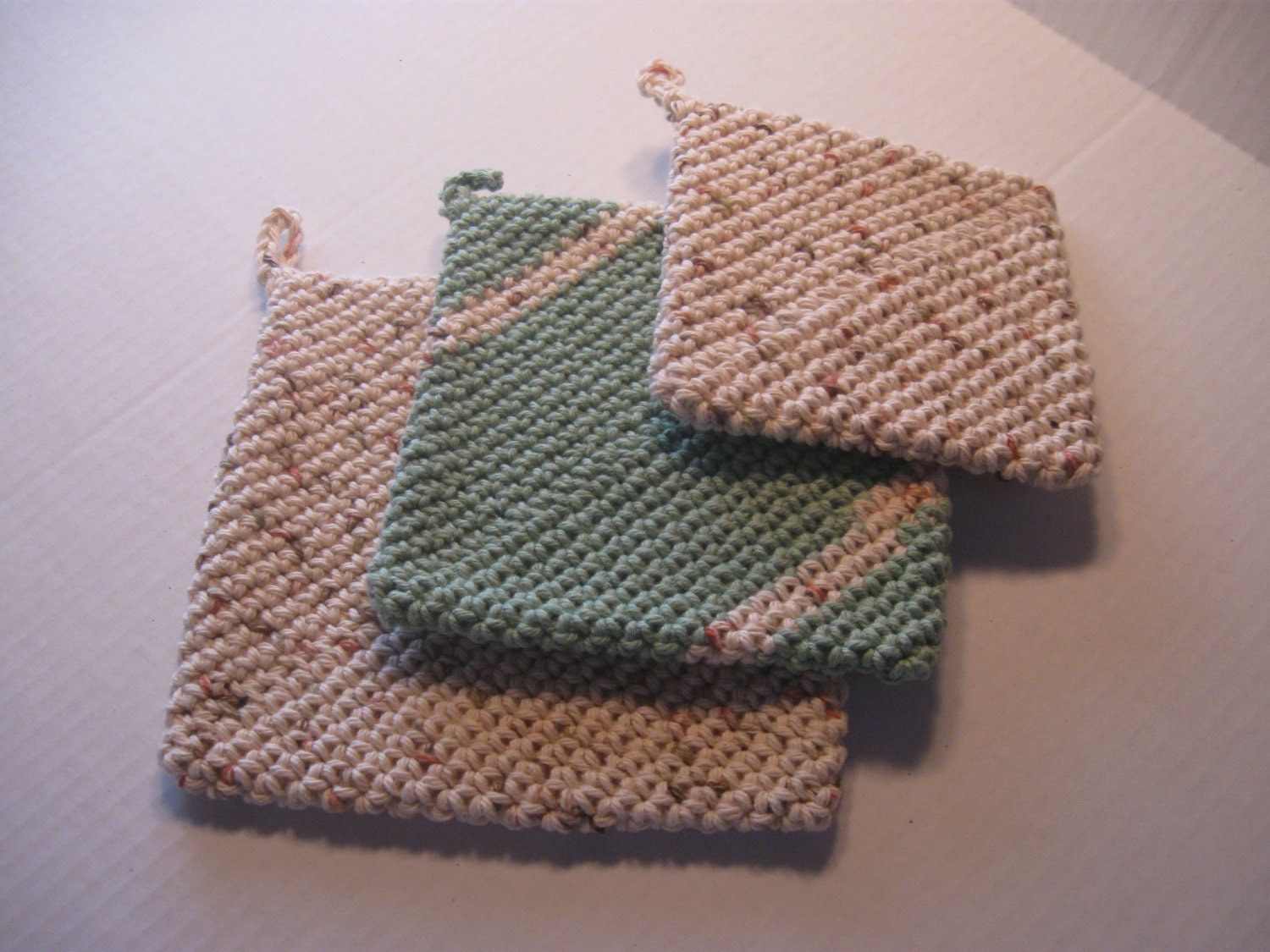 Set of 3 crocheted potholders of double thickness in greens and tans