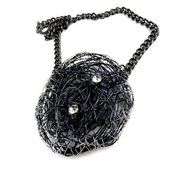 Gift for her. Over-sized black pendant with silver trim.  Metal with rhinestone embellishments.  Fashion Brand Faina.
