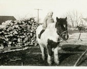 Vintage photo Little Donovan Rides on Pony with a winter Coat