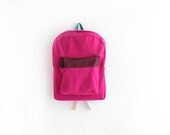 Magenta wool backpack with burgundy pouch.