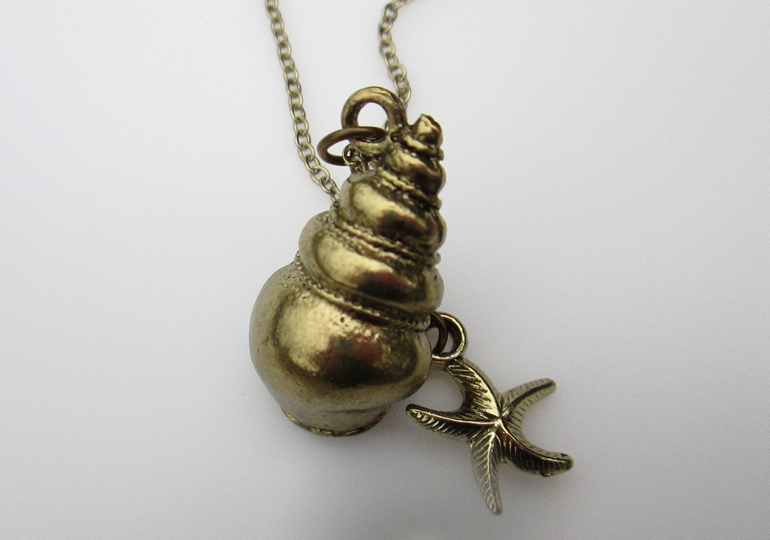 Nautical Spiral Shell and Starfish Necklace in Antique Gold Finish