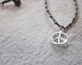 Tiny sterling silver peace sign charm pendant on daintiest crocheted beaded necklace with silver and gray strand