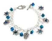 Silver Plated Bracelet with an Array of Stars and Hamsa Chamsa Charms with Emerald Swarovski Crystals