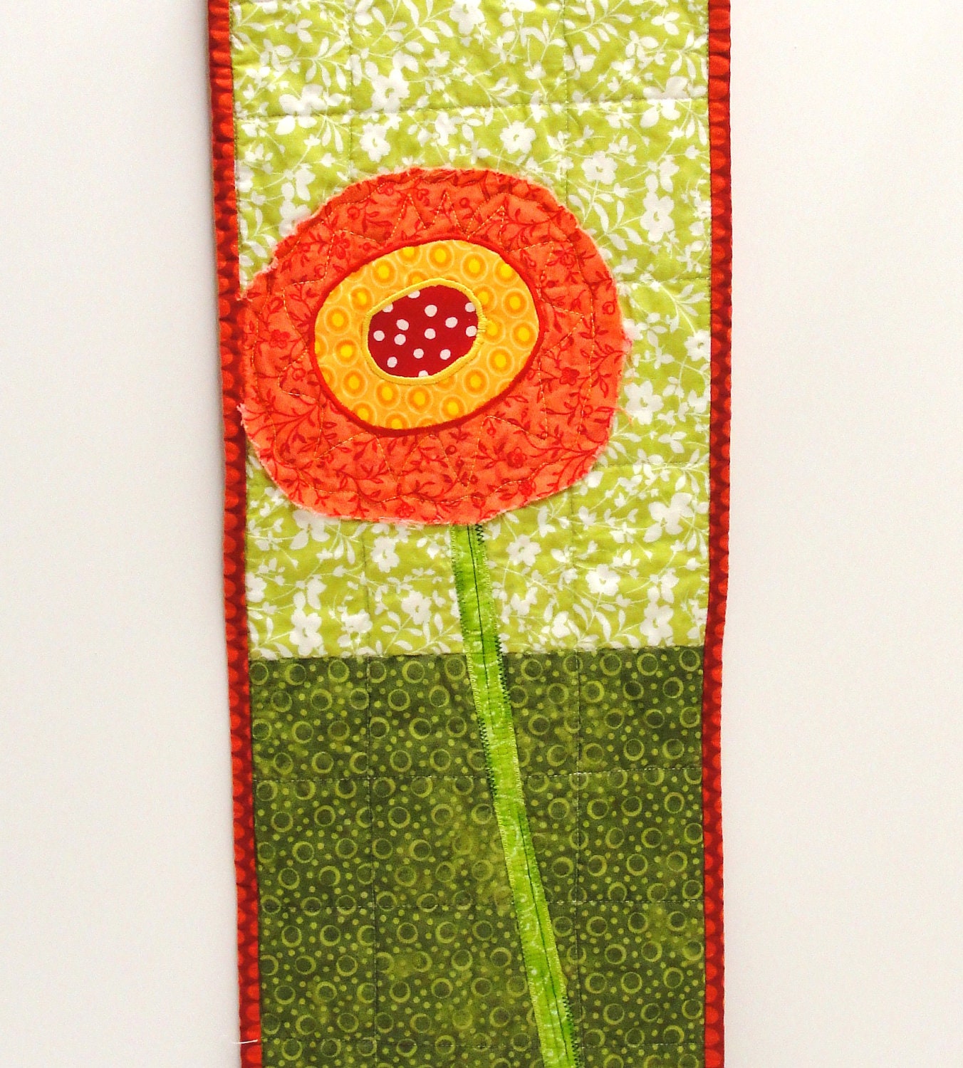 poppy wall quilt- single stem orange, yellow and red poppy on green, wall art, wall hanging