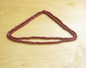 Oxblood beads and string long beaded necklace.