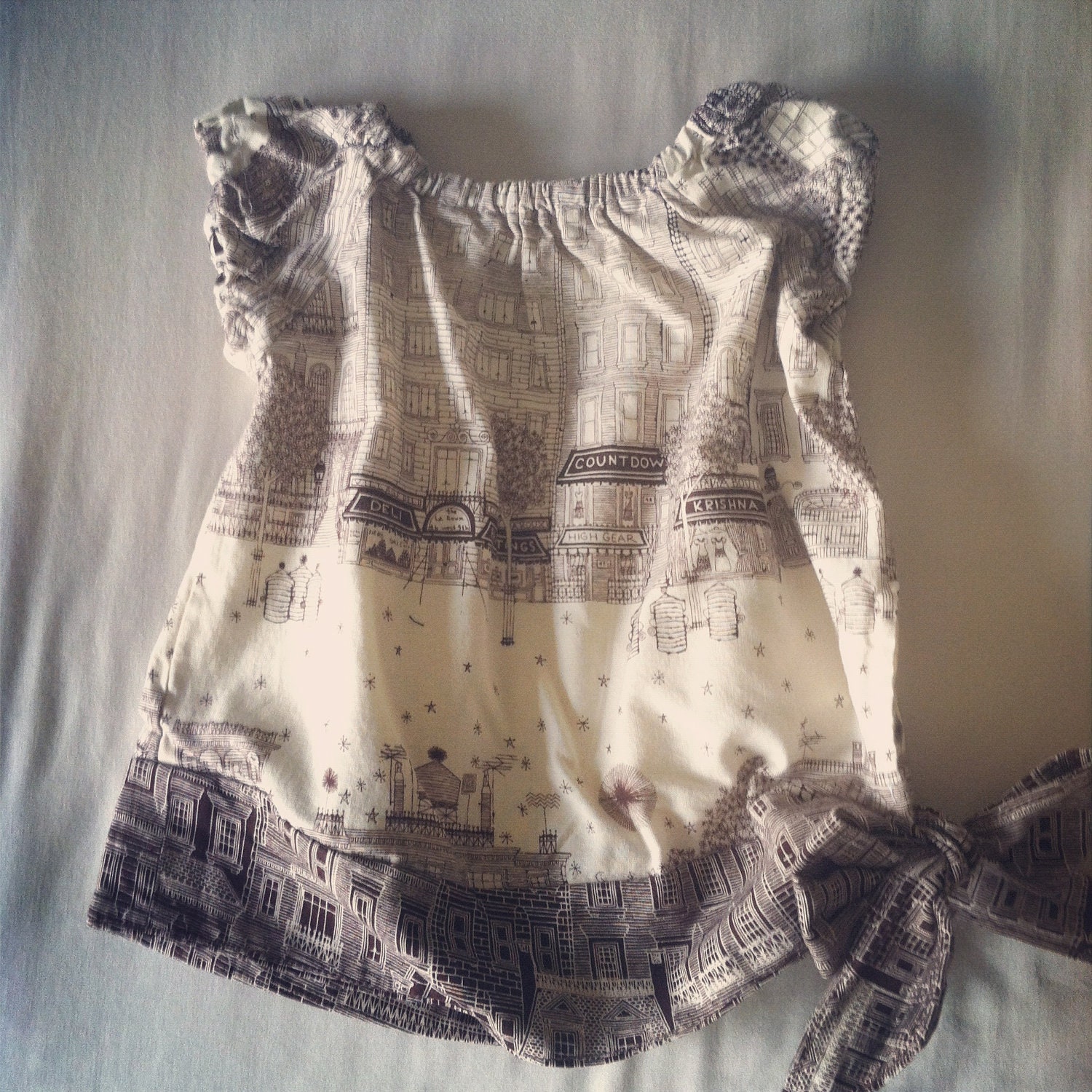 cream and brown city scape side tie blouse