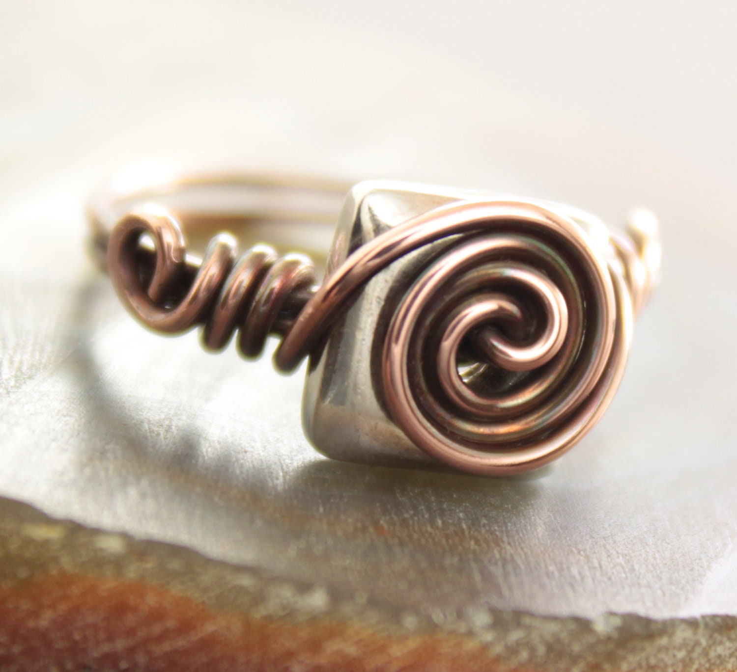 Solid copper with square pillow shape sterling silver bead wrapped ring. Sizes 5-12.