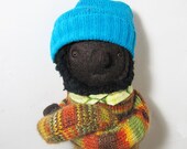 Brown Skinned Plush Boy in Striped Sweater and Blue Hat