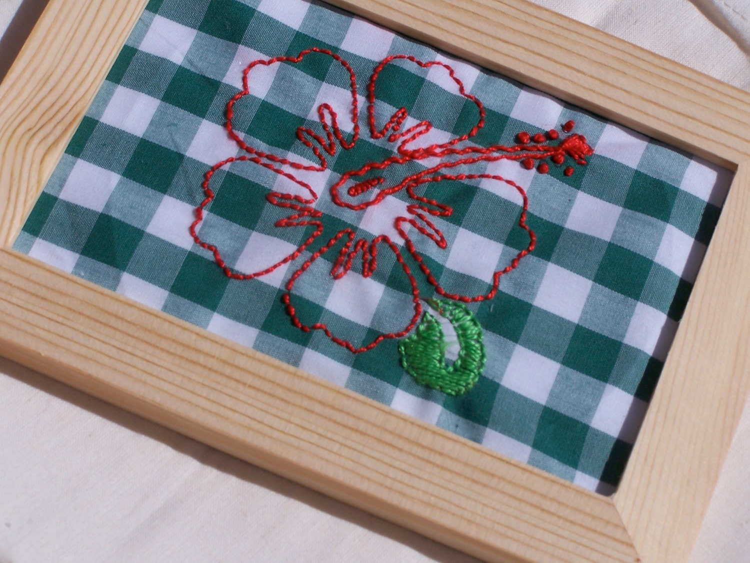 Hand Embroidery pattern, hibiscus design hand stamped, green and white gingham fabric, embroidery floss, needle.