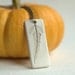 Solitary - A sweet porcelain pendant with impression of a tiny leaf.