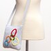 Olympic spirit in a gray messenger purse