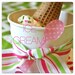 large paper ice cream cup with party sticker and wooden spoons
