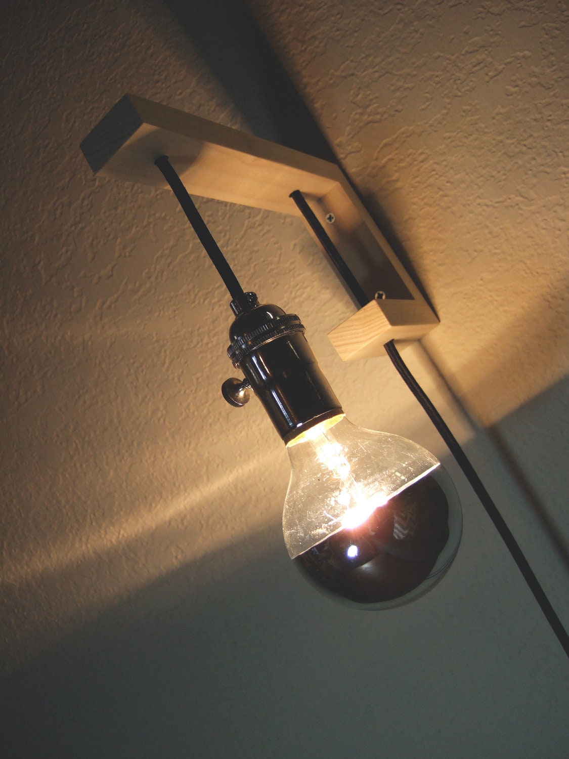 sconce.  little j.  with chrome tipped lightbulb.