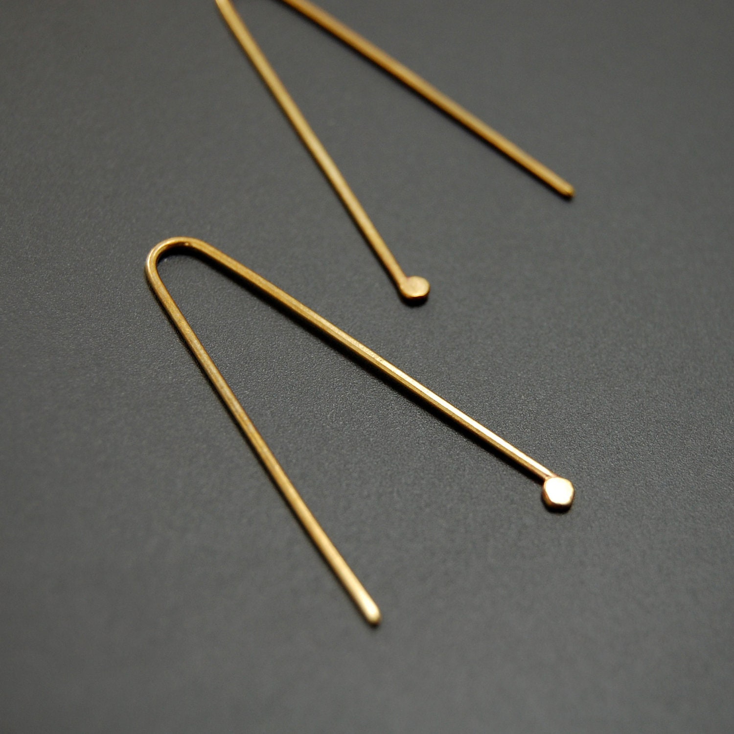 Nazca lines dangle earrings, brass