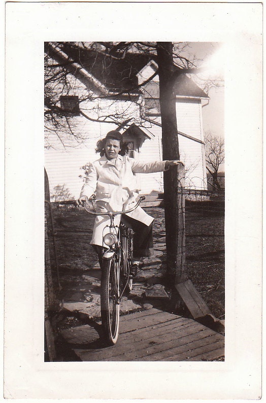 Vintage Photograph of girl signaling on a bike