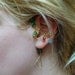 The Legend of Zelda's Wise Ear Bend with Hanging Spiritual Stones and Triforce