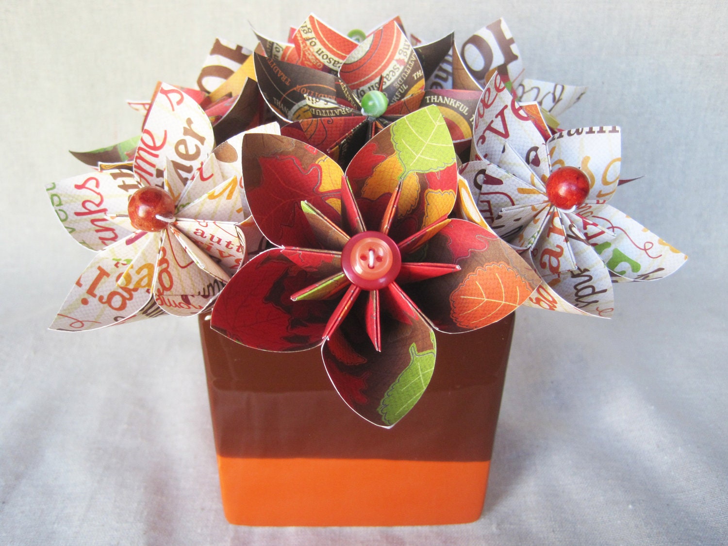 Thanksgiving paper flower arrangement in ceramic vase, brown and orange